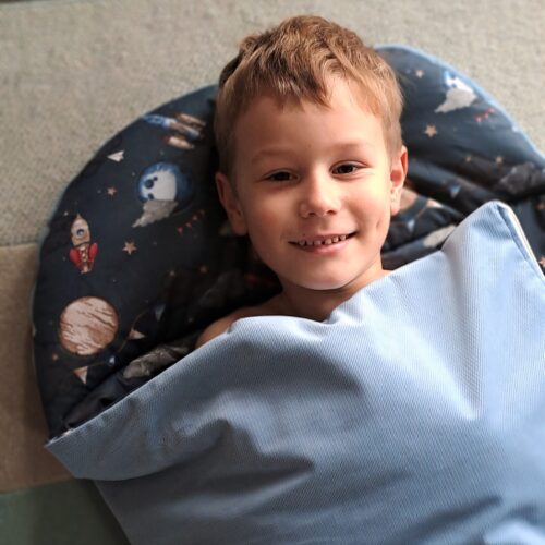 śpiworek do spania do przedszkola niebieski chłopczyk uśmiechnięty